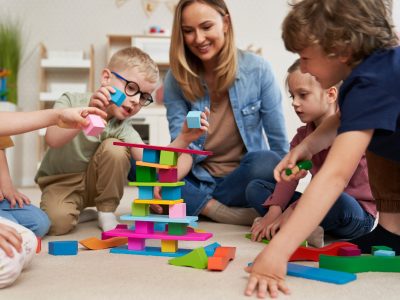 Children playing with toy blocks in the kindergarten